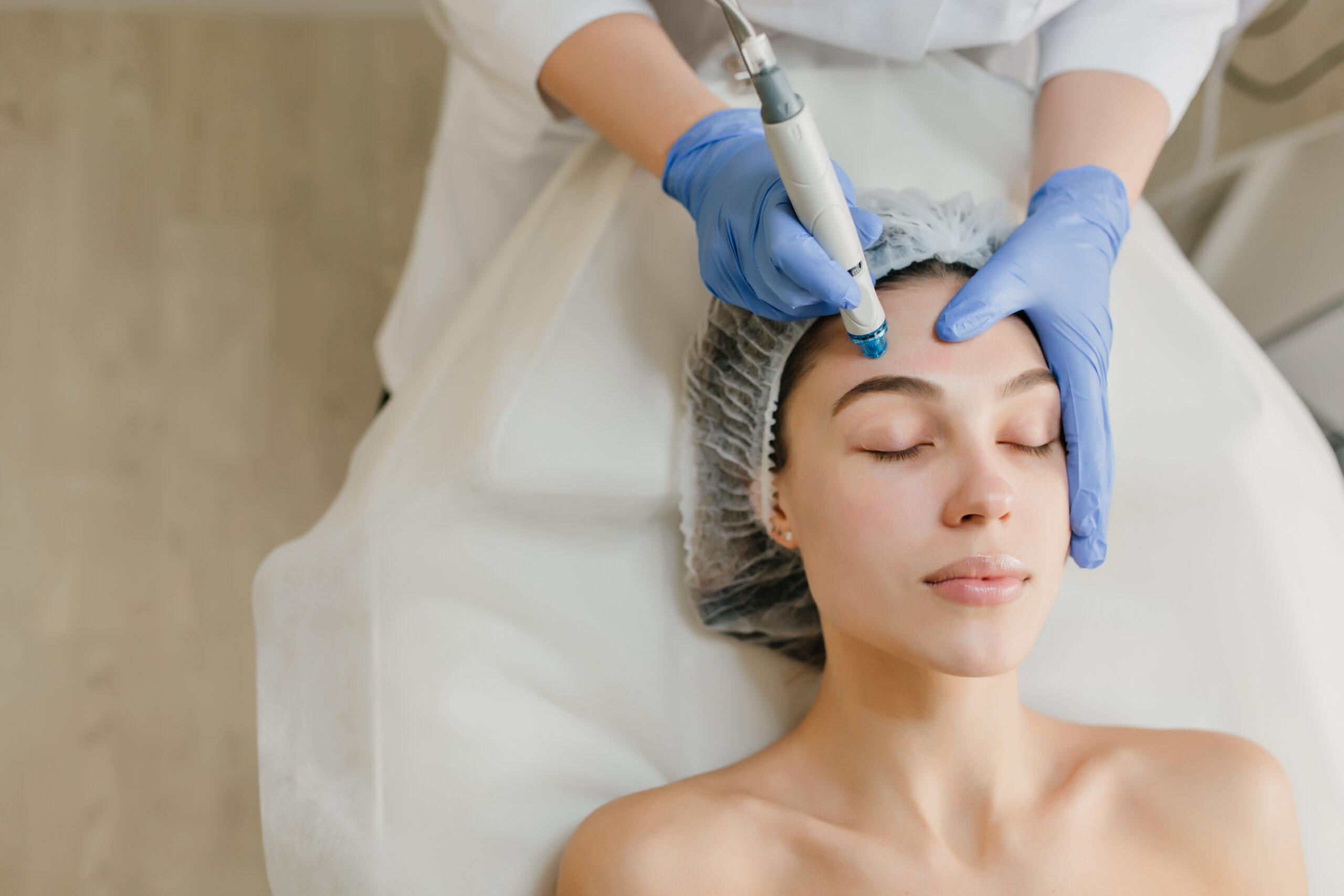 View from above of beautiful woman enjoying cosmetology procedures, rejuvenation in beauty salon. Dermatology, doctor at work, healthcare, therapy, botox. Place for text.
